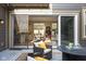 Inviting outdoor patio with wicker furniture, transitioning through sliding glass doors into a spacious living area at 7152 Cherry Creek Blvd, Carmel, IN 46033
