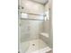 Modern shower with glass enclosure, built-in bench, and tiled walls, for a spa-like experience at 7152 Cherry Creek Blvd, Carmel, IN 46033
