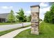 Stone and brick entrance sign for The Grove Legacy neighborhood on a sunny day at 7152 Cherry Creek Blvd, Carmel, IN 46033
