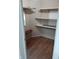 Walk-in closet with shelving for storage and wood-look vinyl flooring at 764 Haugh St, Indianapolis, IN 46222