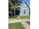 Cozy bungalow features tidy lawn, siding and shade tree at 764 Haugh St, Indianapolis, IN 46222