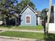 Charming single Gathering home featuring blue wood siding and mature shade tree at 764 Haugh St, Indianapolis, IN 46222