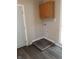 A view of the laundry area featuring overhead cabinets and gray accent flooring at 764 Haugh St, Indianapolis, IN 46222