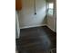 View of the laundry room with dark wood flooring and natural light from the window at 764 Haugh St, Indianapolis, IN 46222