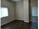 A view of the living room with dark wood flooring and a window providing natural light at 764 Haugh St, Indianapolis, IN 46222