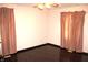 Bedroom featuring hardwood floors, ceiling fan, and large window with curtains at 7931 Guion Rd, Indianapolis, IN 46268