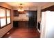 Kitchen with dark wood cabinets, hardwood floors, and a bright, sunny window at 7931 Guion Rd, Indianapolis, IN 46268