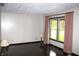Bright living room with hardwood floors, neutral walls, and large window with curtains at 7931 Guion Rd, Indianapolis, IN 46268