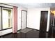 Living room with hardwood floors, neutral walls, and large window with curtains at 7931 Guion Rd, Indianapolis, IN 46268