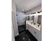 Elegant bathroom with a walk-in glass shower and a double vanity with modern lighting fixtures at 811 E Minnesota St, Indianapolis, IN 46203