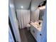 Well-lit bathroom with a white vanity, modern fixtures, and a bathtub with a shower at 811 E Minnesota St, Indianapolis, IN 46203