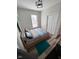 A cozy bedroom features a modern platform bed with grey, white, and blue bedding, and a closet at 811 E Minnesota St, Indianapolis, IN 46203
