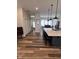 Open concept design with an island and barstool seating, stainless steel appliances, and modern lighting at 811 E Minnesota St, Indianapolis, IN 46203