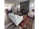 The stylish living room flows into the kitchen, featuring a stone fireplace and sleek modern decor at 811 E Minnesota St, Indianapolis, IN 46203