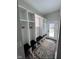 Organized mudroom with custom built-in shelving, a bench, and a stylish rug, blending function with style at 811 E Minnesota St, Indianapolis, IN 46203
