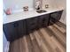 Modern wet bar area with sleek black cabinets, a beverage fridge, and a quartz countertop at 811 E Minnesota St, Indianapolis, IN 46203