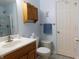 Cozy bathroom with a white vanity, wood cabinets, and modern fixtures at 8346 Weathervane Cir, Indianapolis, IN 46239