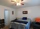 Well-lit bedroom featuring ceiling fan, neutral carpet, and cozy furniture at 8346 Weathervane Cir, Indianapolis, IN 46239