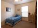 Bright bedroom featuring a window, neutral carpet, and comfortable furniture at 8346 Weathervane Cir, Indianapolis, IN 46239
