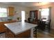 Well-lit kitchen with island seating and an adjacent dining area, perfect for Gathering meals at 8346 Weathervane Cir, Indianapolis, IN 46239