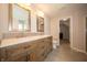 Bright bathroom featuring a double vanity with neutral color palette and wood grain cabinets at 8710 N Aspen Way, McCordsville, IN 46055