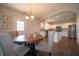 Bright dining area with an arched doorway to the modern kitchen with stainless steel appliances and granite countertops at 8710 N Aspen Way, McCordsville, IN 46055