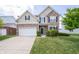 Charming two-story home with stone and siding, a two-car garage, and a well-manicured lawn at 8710 N Aspen Way, McCordsville, IN 46055