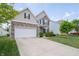 Two-story home with stone and siding, featuring a two-car garage, and well-maintained front lawn at 8710 N Aspen Way, McCordsville, IN 46055