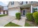 Inviting front entrance of a two-story home with a stone facade and a two-car garage at 8710 N Aspen Way, McCordsville, IN 46055