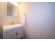 Modern half bathroom featuring a vanity with a white countertop and a round mirror at 8710 N Aspen Way, McCordsville, IN 46055