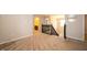 Bright hallway leading to a staircase with dark railing, carpet, and open floorplan at 8710 N Aspen Way, McCordsville, IN 46055