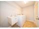 Functional laundry room equipped with a sink, washing machine, dryer and storage rack at 8710 N Aspen Way, McCordsville, IN 46055