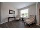 Cozy living room with neutral walls, wood floors, and two comfortable chairs near window at 8710 N Aspen Way, McCordsville, IN 46055