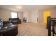 Upstairs living room with carpeted floor and brown leather sofa at 8710 N Aspen Way, McCordsville, IN 46055