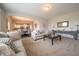 Open concept living room with neutral paint, plush carpet, and elegant decor flows into the dining area and kitchen at 8710 N Aspen Way, McCordsville, IN 46055