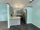 Modern kitchen with stainless steel appliances, gray cabinets, and a stylish light fixture at 892 Millbrook Dr, Avon, IN 46123
