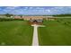 Drone shot shows log cabin on a vast lawn with ample space and surrounding farm fields at 8981 N 325 E, Columbus, IN 47203