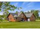 Charming log home featuring a spacious backyard and a cozy outdoor seating area at 8981 N 325 E, Columbus, IN 47203