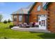 Log home exterior with a patio, outdoor seating, and a playhouse at 8981 N 325 E, Columbus, IN 47203