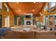 Spacious living area with stone fireplace, hardwood floors, log walls, and ample seating at 8981 N 325 E, Columbus, IN 47203