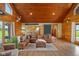 Open-concept living area featuring log walls, hardwood floors and natural light at 8981 N 325 E, Columbus, IN 47203