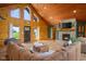 Spacious living room featuring a stone fireplace, log walls, and a cozy seating area at 8981 N 325 E, Columbus, IN 47203