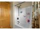 Clean white shower with built-in shelves and a decorative shower curtain at 8981 N 325 E, Columbus, IN 47203
