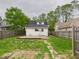 View of backyard with stone pathway, black roof and white siding at 907 S A St, Elwood, IN 46036