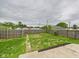 Fenced backyard featuring a well maintained lawn and partial concrete patio area at 907 S A St, Elwood, IN 46036
