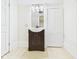 Bathroom with vanity, mirror, and tiled floors, complemented by soft lighting at 907 S A St, Elwood, IN 46036