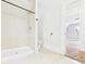Bathroom with a tiled shower stall, toilet, and an open doorway to an adjacent room at 907 S A St, Elwood, IN 46036