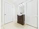 Bathroom with vanity, mirror, tiled floors, and two access doors at 907 S A St, Elwood, IN 46036