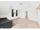Neutral carpeted bedroom with a double-hung window and access to an adjacent room at 907 S A St, Elwood, IN 46036