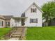 Charming two-story home with a front yard and concrete steps leading to the entrance at 907 S A St, Elwood, IN 46036